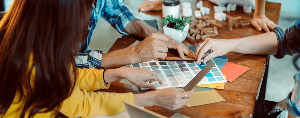Design team collaborating on materials and color swatches