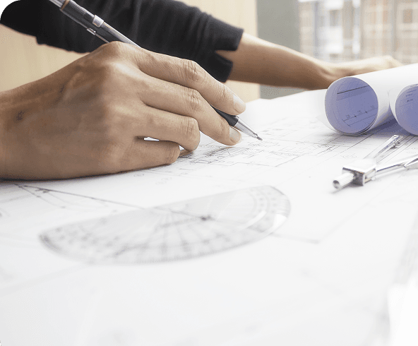 Hands measuring on drafting paper